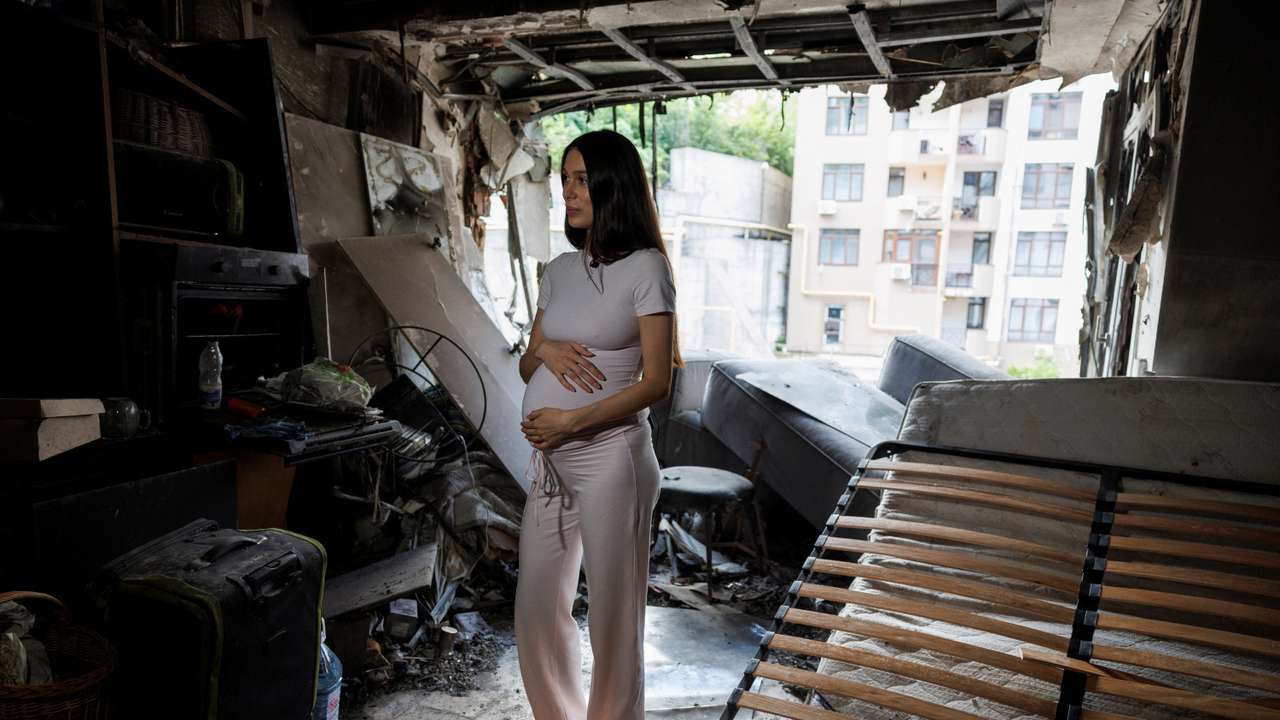 Bohdana Zhupanyna stands inside of her apartment damaged by a Russian drone strike in Kyiv