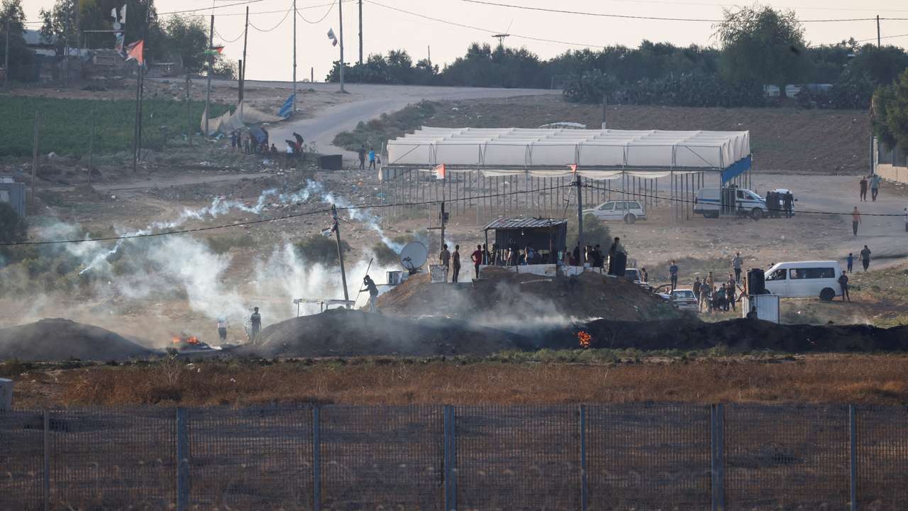 Israeli soldiers and Palestinian protesters clash near the border between Israel and the Gaza Strip as seen from the Israeli side