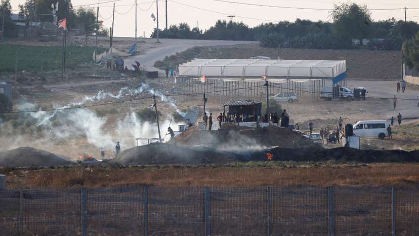 Israeli soldiers and Palestinian protesters clash near the border between Israel and the Gaza Strip as seen from the Israeli side