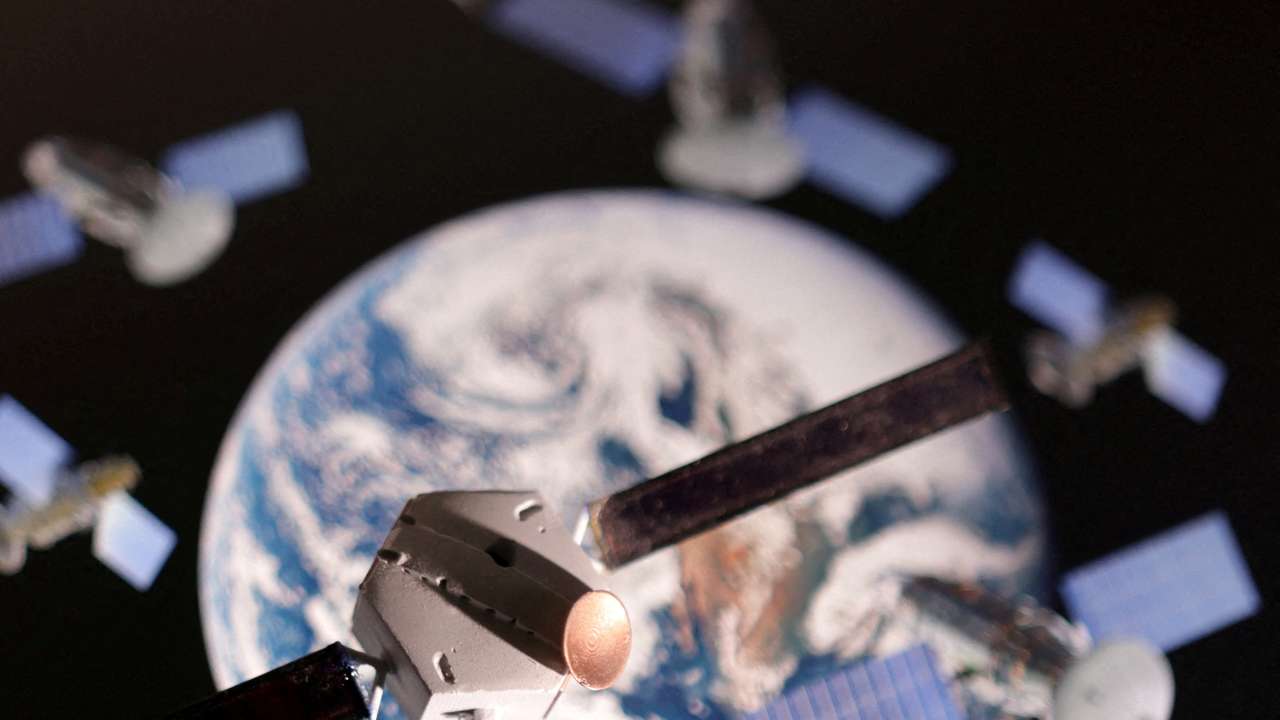 FILE PHOTO: Illustration shows a satellite model placed on picture of Earth