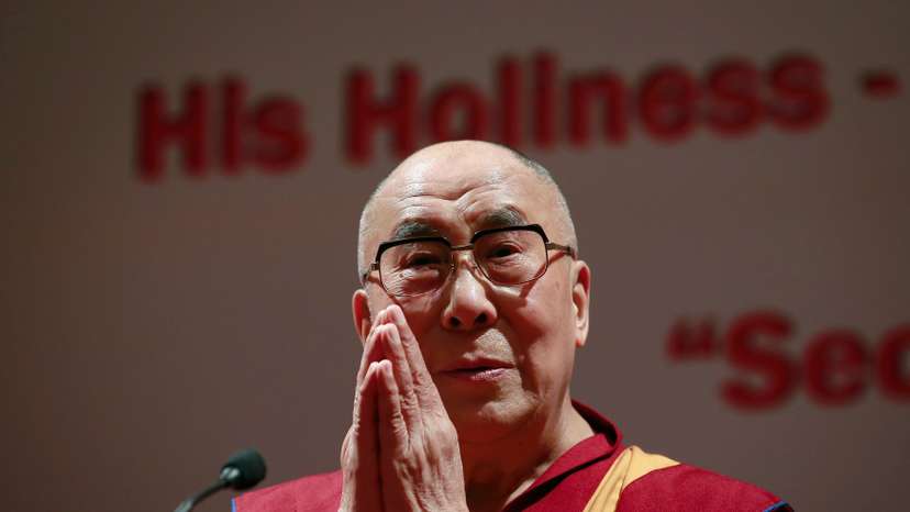 Exiled Tibetan spiritual leader the Dalai Lama gestures during a speech at the 108th anniversary of Indian Merchant Chambers in Mumbai
