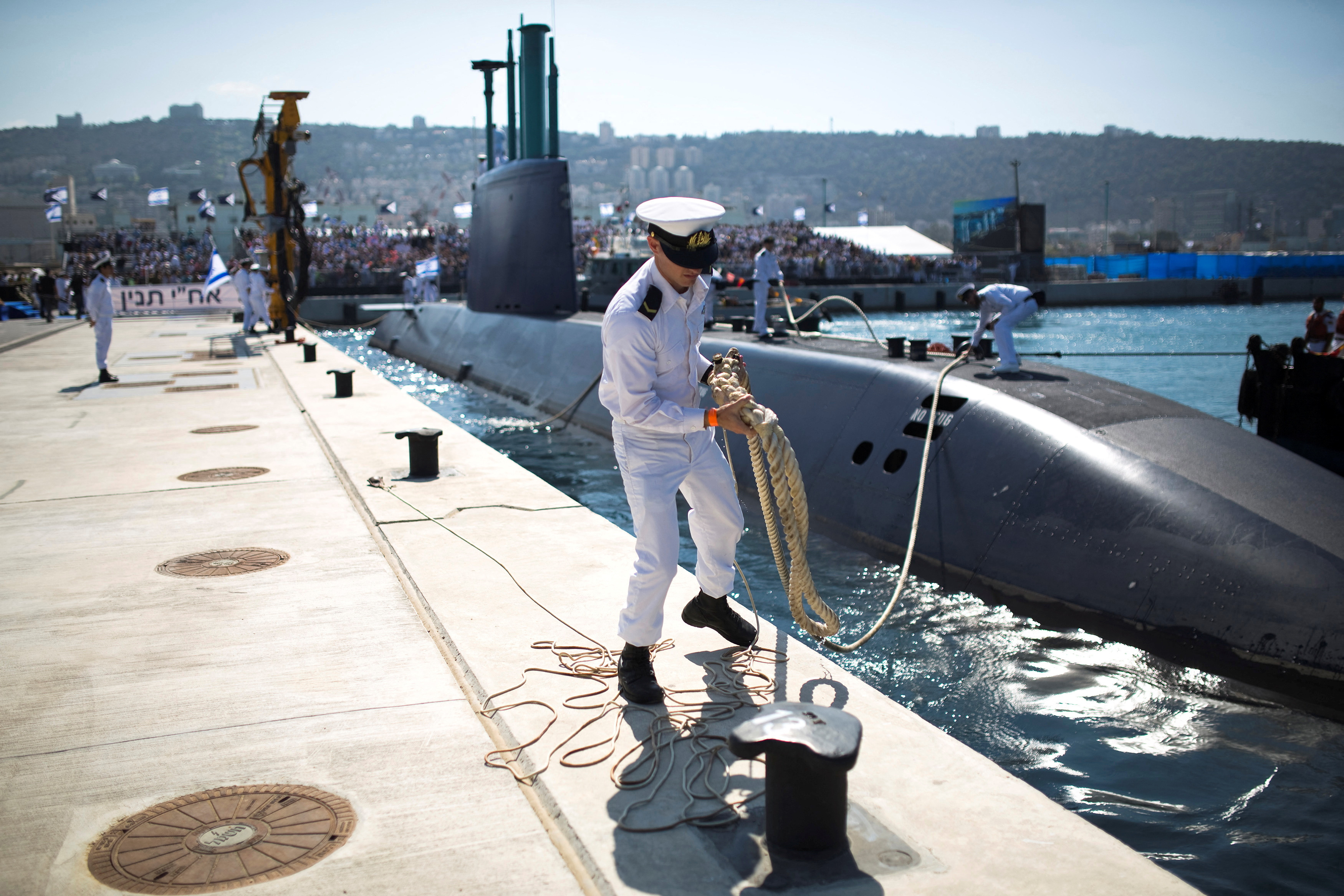 FILE PHOTO: An Israeli naval officer stands on the pier in Haifa as INS Tanin docks after its arrival in Israel