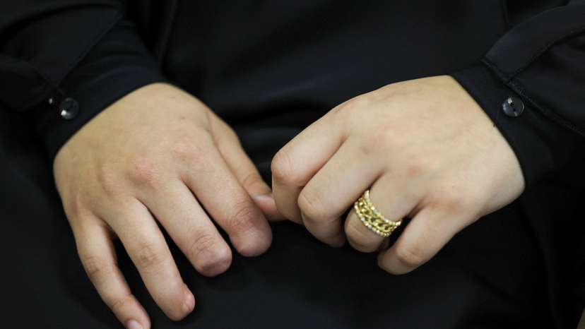 Zainab Mustarah who was wounded when pagers detonated across Lebanon sits in a room with some fingers missing in Beirut