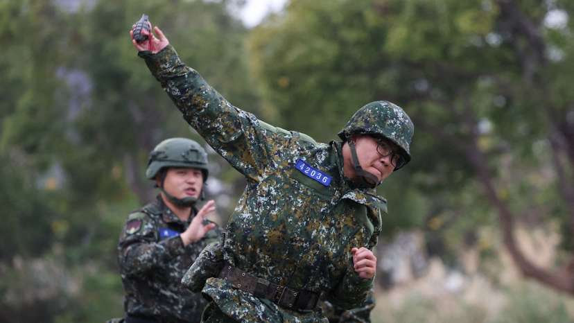 A soldier trains to throw grenade ahead of the Lunar New Year at an army base in Hsinchu