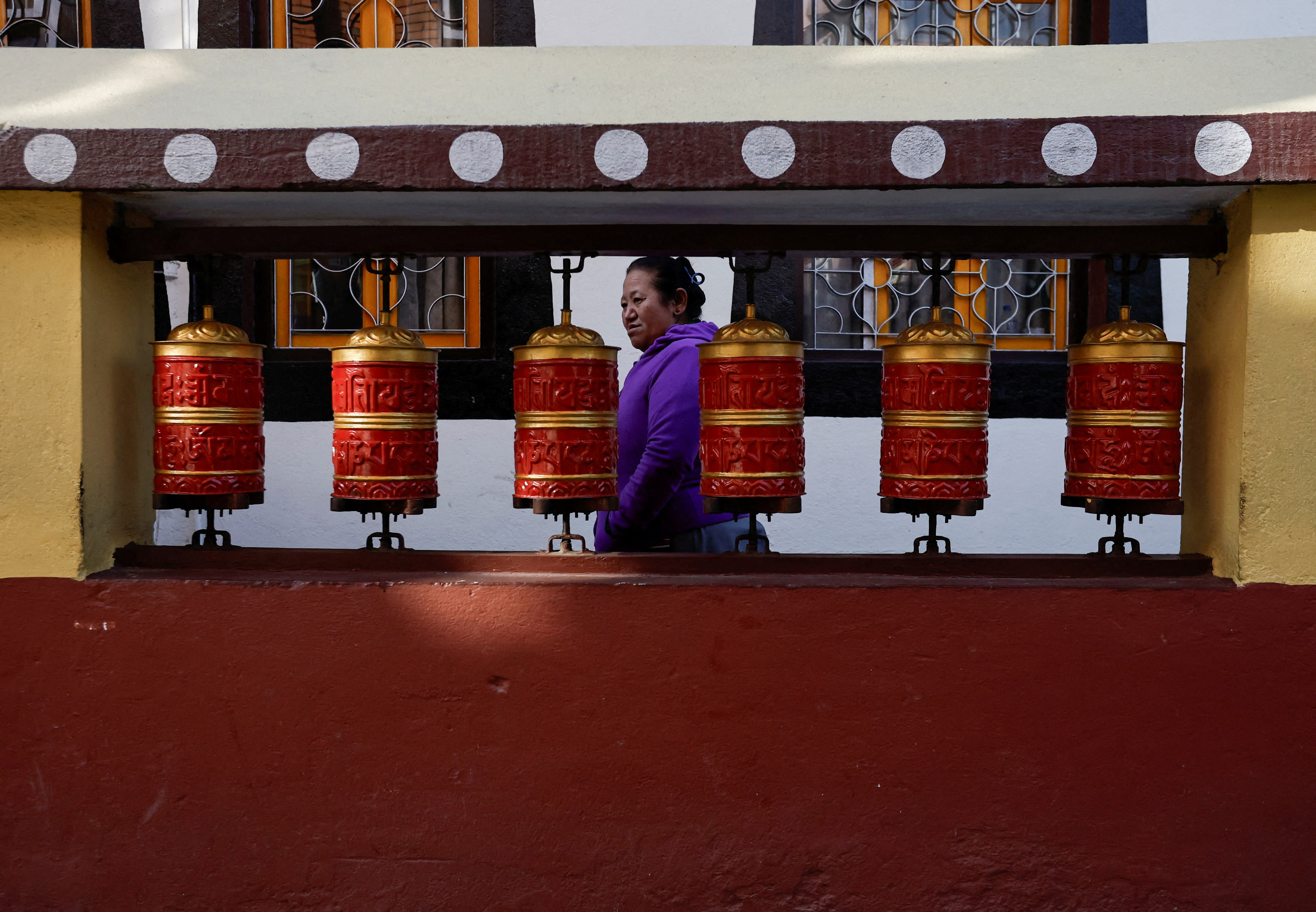 Tibetans in Nepal offer prayers at a monastery in memory of those killed in the recent earthquake, at the Tibetan Refugee Camp in Lalitpur