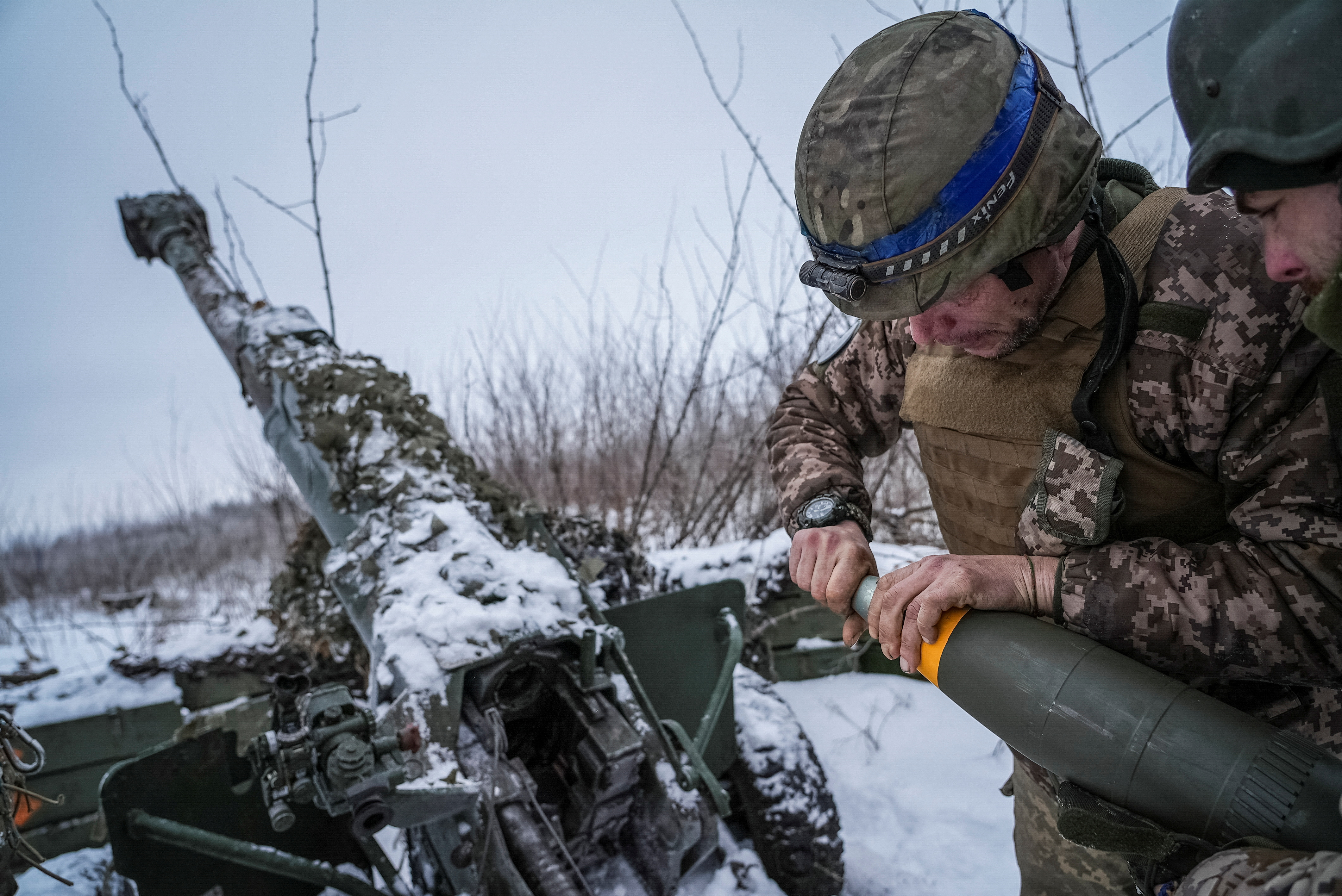 FILE PHOTO: Ukrainian servicemen prepare fire a 120-mm towed artillery pieces-mortar towards Russian troops at a position near Bakhmut
