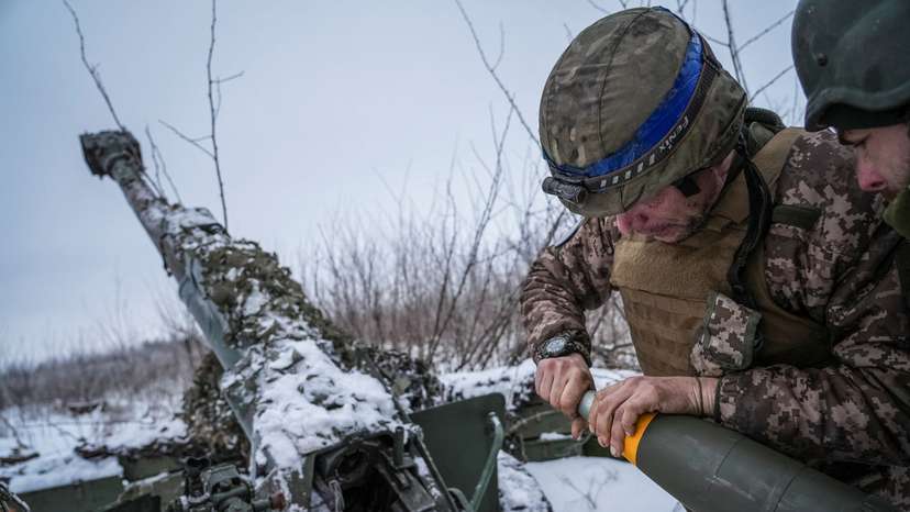 FILE PHOTO: Ukrainian servicemen prepare fire a 120-mm towed artillery pieces-mortar towards Russian troops at a position near Bakhmut