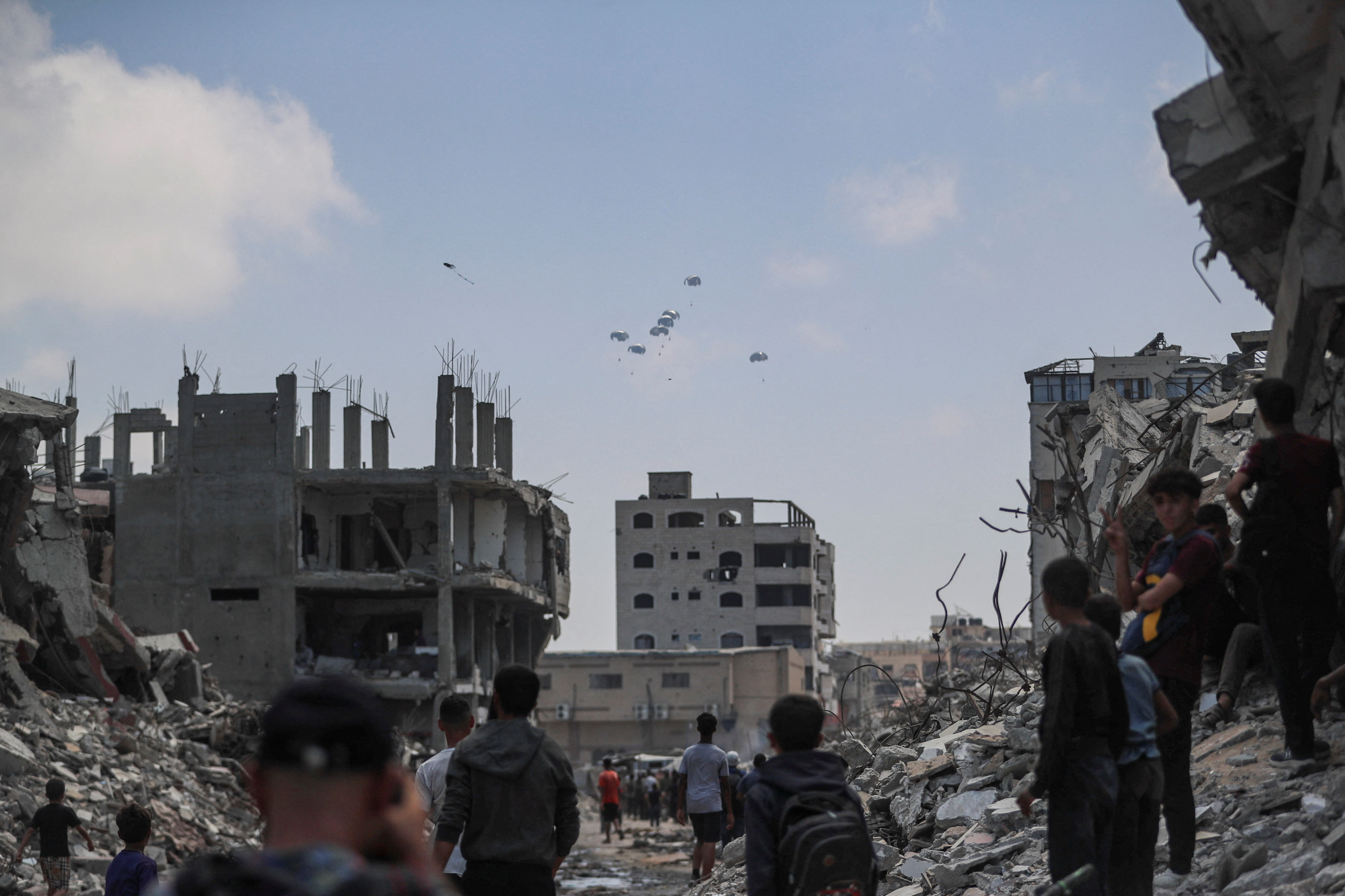 Aid packages are airdropped over Gaza, as seen from Gaza City