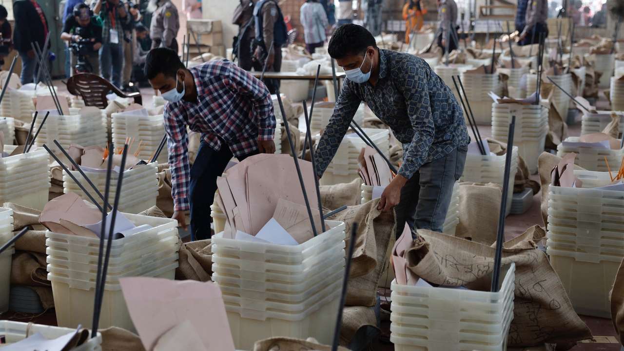 Officials give a final check before dispatching the ballot boxes to voting centres, a day ahead of the national election in Dhaka
