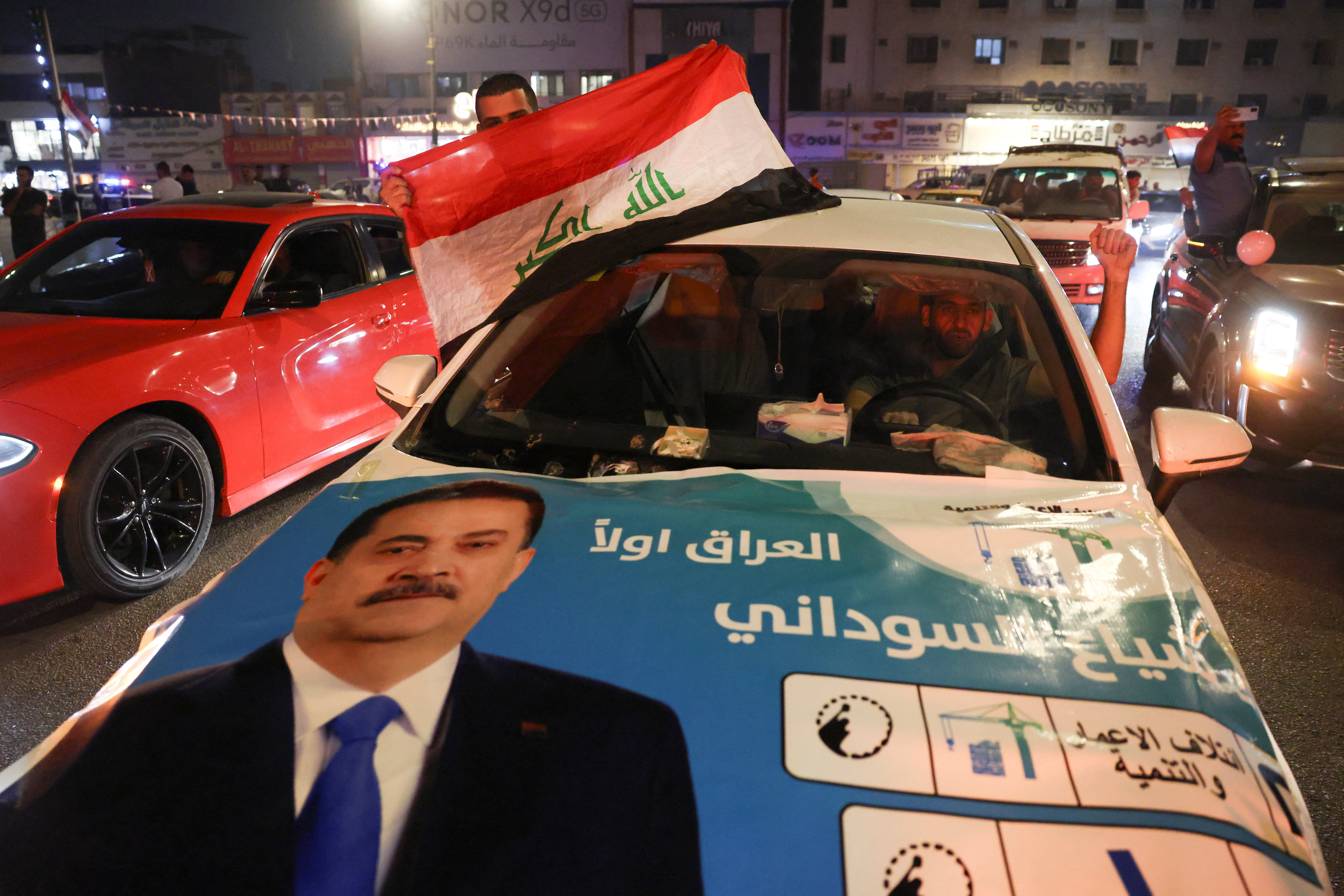 Supporters of the Reconstruction and Development Coalition celebrate after preliminary election results were announced in Baghdad