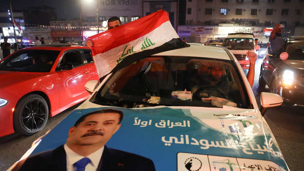 Supporters of the Reconstruction and Development Coalition celebrate after preliminary election results were announced in Baghdad