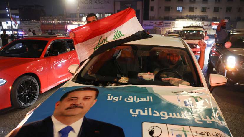 Supporters of the Reconstruction and Development Coalition celebrate after preliminary election results were announced in Baghdad