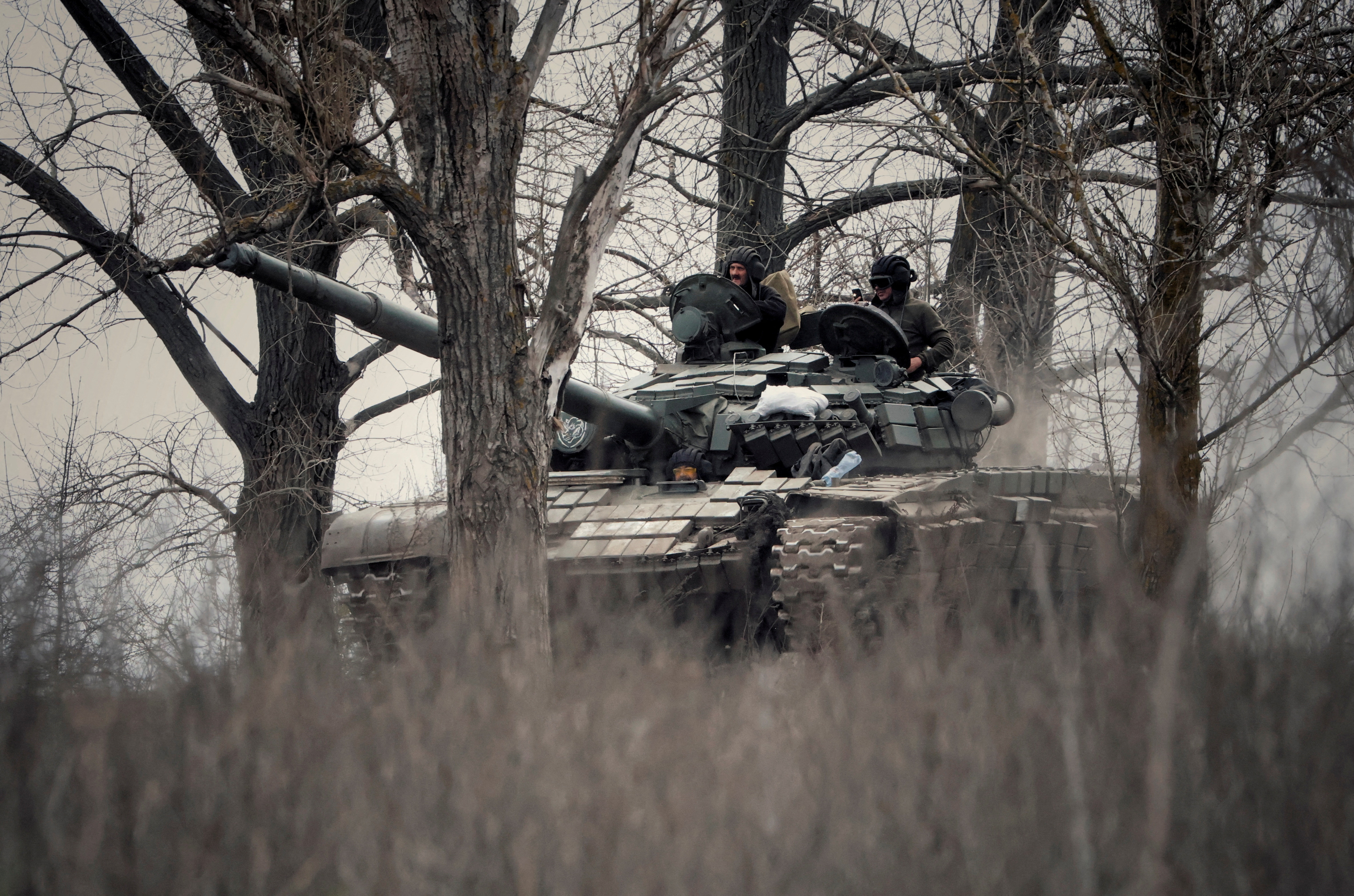 Ukrainian service members ride a tank in Donbas region