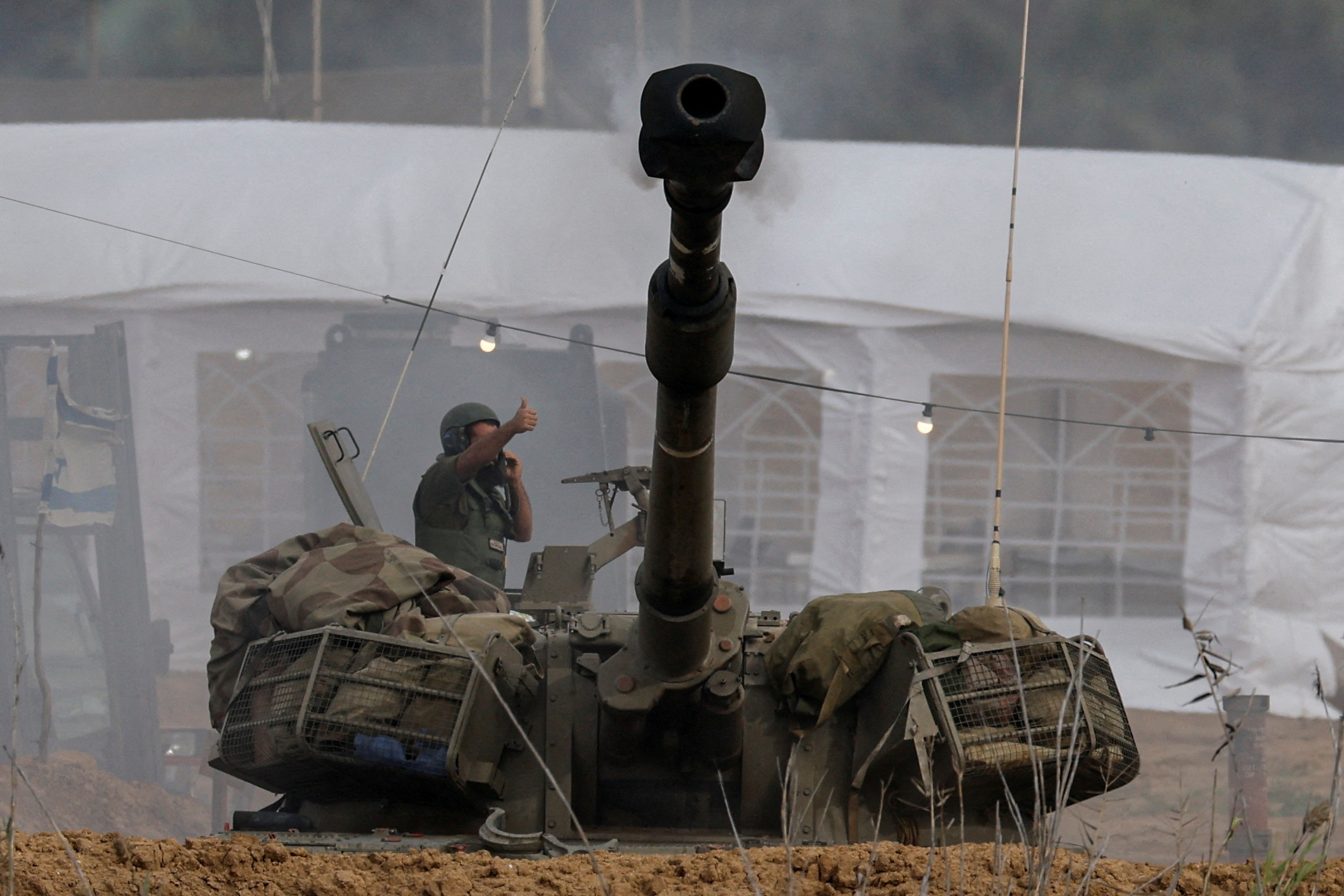 An Israeli artillery unit fires near the Israel-Gaza border
