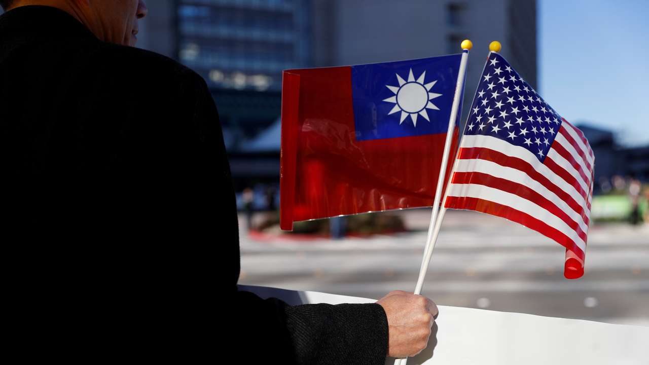 A demonstrator holds flags of Taiwan and the United States in support of Taiwanese President Tsai Ing-wen during an stop-over after her visit to Latin America in Burlingame