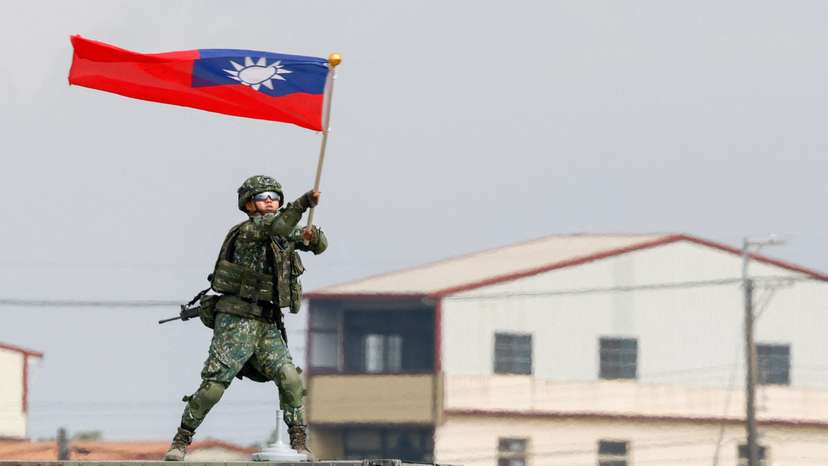 Taiwanese army soldier waves a flag during an annual military exercise ahead of Lunar New Year in Taichung