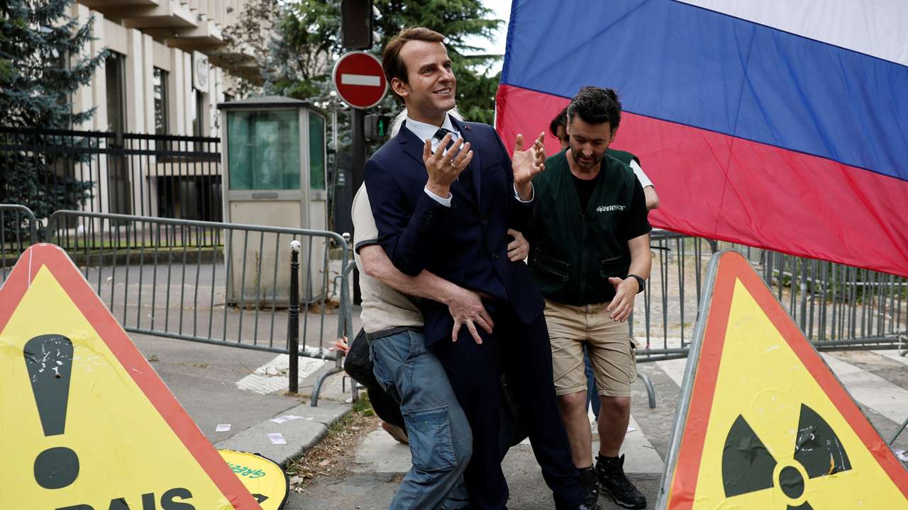 Activists of Greenpeace attend a protest near the Russian Embassy in Paris