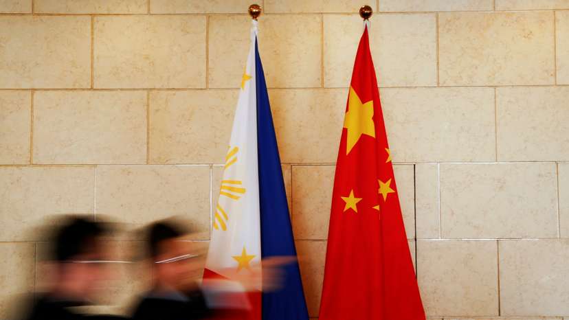 National flags are placed outside a room where Philippine Finance Secretary Carlos Dominguez and China's Commerce Minister Gao Hucheng address reporters after their meeting in Beijing