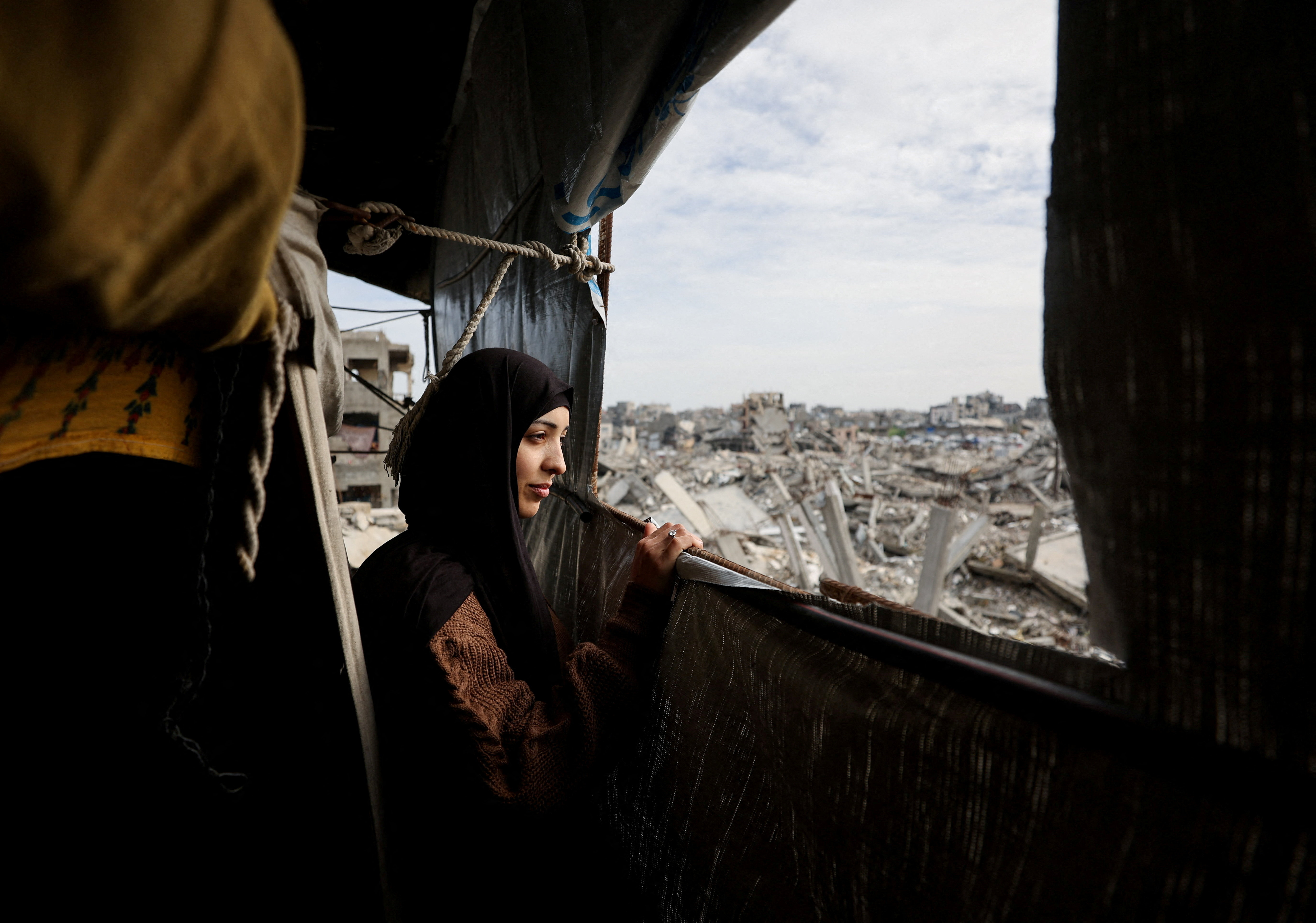 Palestinian mother of three Eatedal Rayyan returns to her war-damaged home in northern Gaza Strip following medical treatment in Egypt
