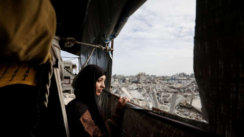 Palestinian mother of three Eatedal Rayyan returns to her war-damaged home in northern Gaza Strip following medical treatment in Egypt