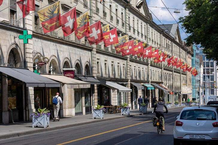FILE PHOTO: Swiss and Canton de Geneve flags are seen in the Corraterie Street in Geneva