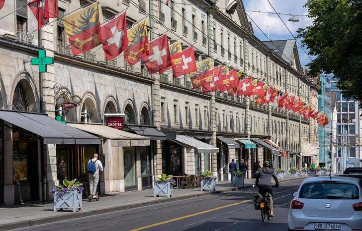 FILE PHOTO: Swiss and Canton de Geneve flags are seen in the Corraterie Street in Geneva