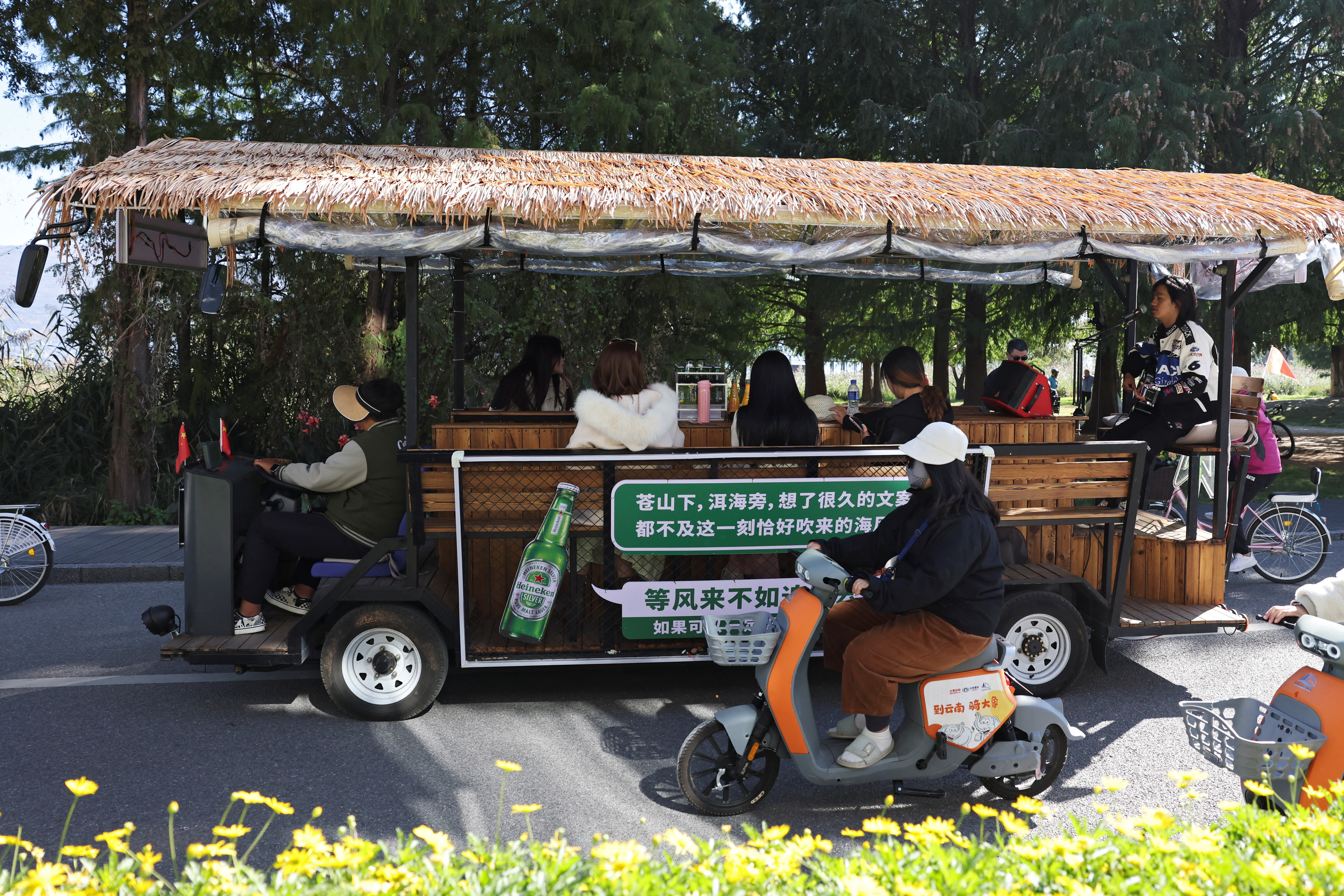 Man sings for customers touring the Erhai lake on a sightseeing bus, in Dali