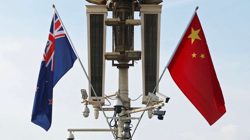 Flags of New Zealand and China flutter in Beijing