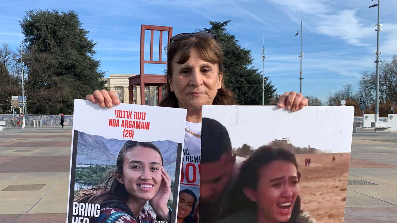 Ohad, aunt of Noa Argamani who was taken hostage by Hamas during the October 7 attack, poses with posters in Geneva