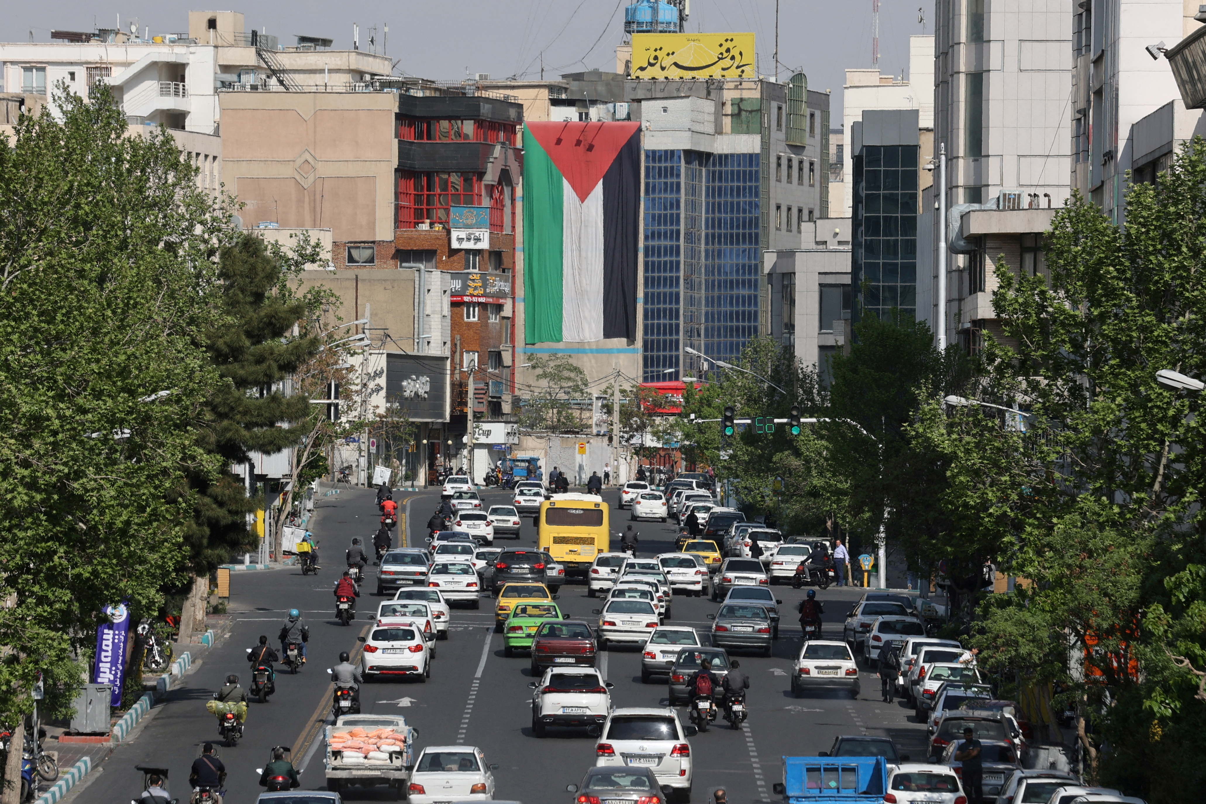 A huge Palestinian flag is seen on a building in a street in Tehran