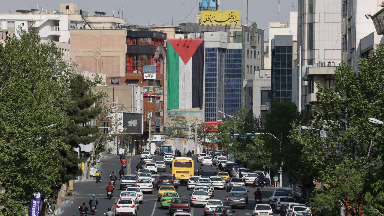 A huge Palestinian flag is seen on a building in a street in Tehran