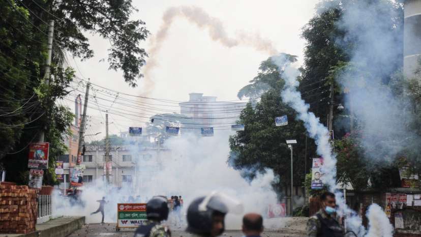 Security forces throw tear gas cans and sound grenades to disperse the Awami League supporters following a clash during the National Citizen Party rally, in Gopalganj