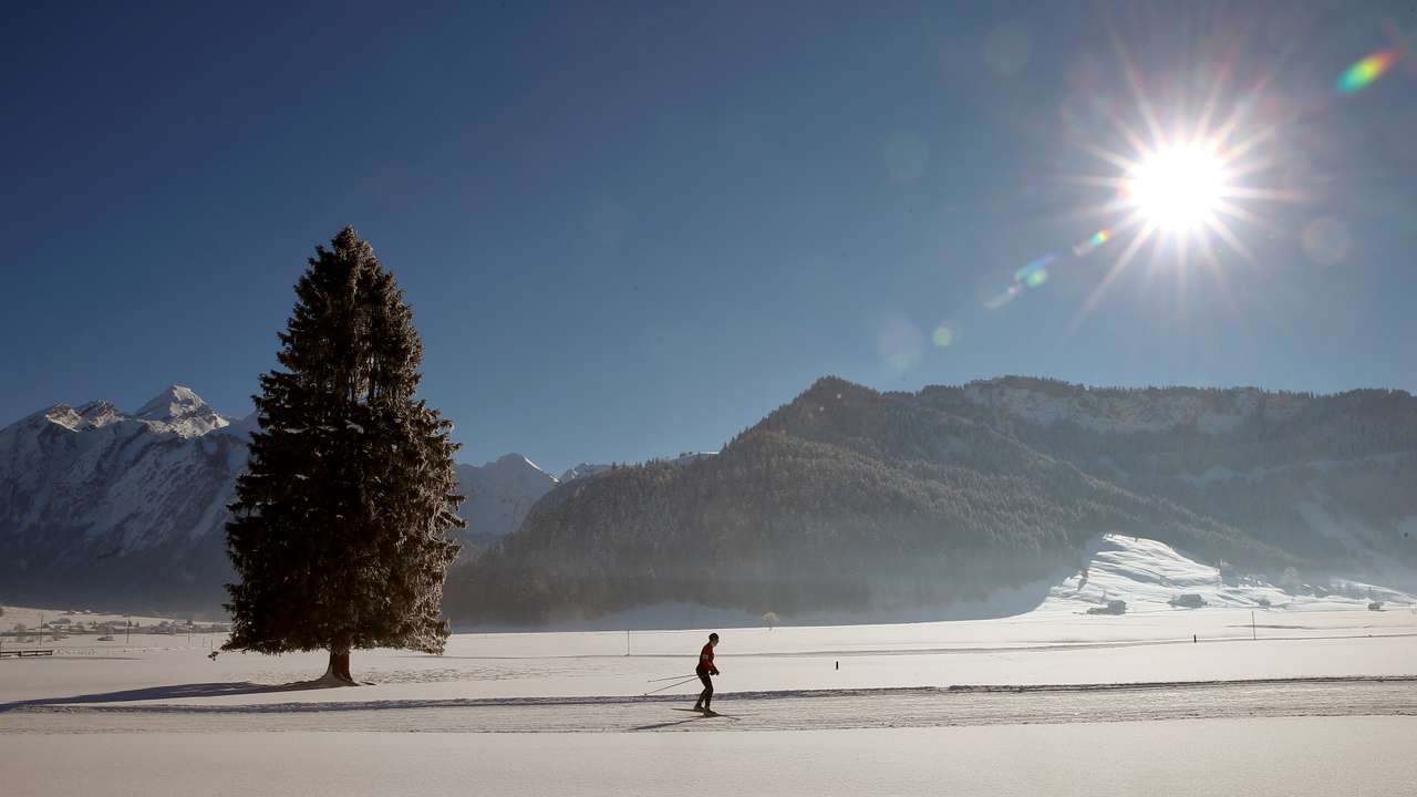 A cross-country skier is seen in the snow-covered landscape near Unteriberg