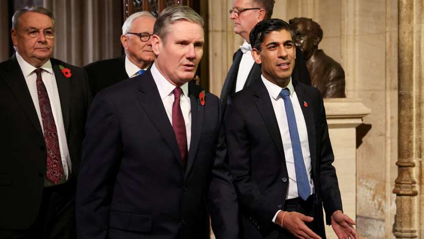 FILE PHOTO: Labour Party leader Sir Keir Starmer walks with Britain's Prime Minister Rishi Sunak during the State Opening of Parliament ceremony, at the Houses of Parliament