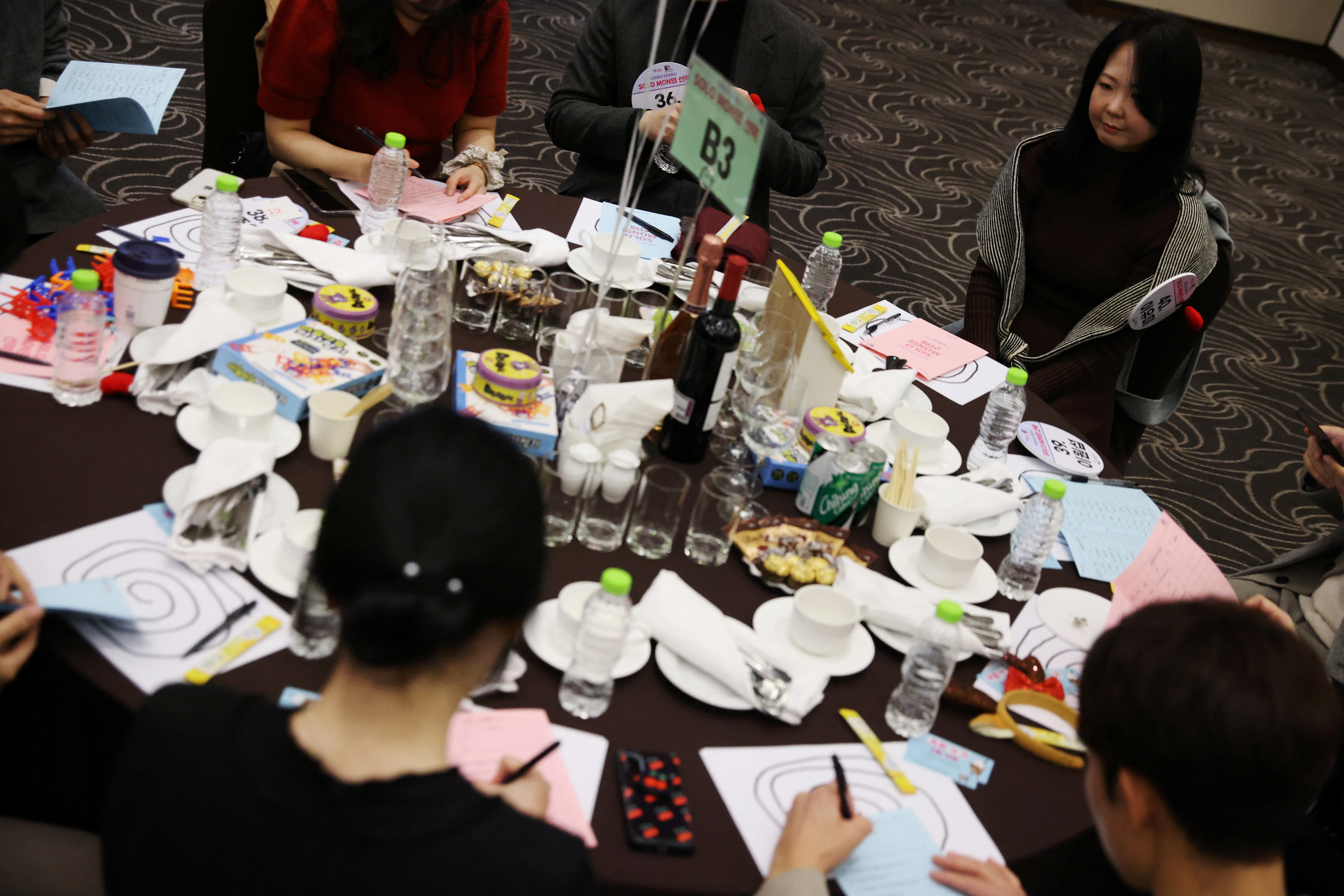 Lee Yu-mi sits along with other participants during a mass blind date event in Seongnam
