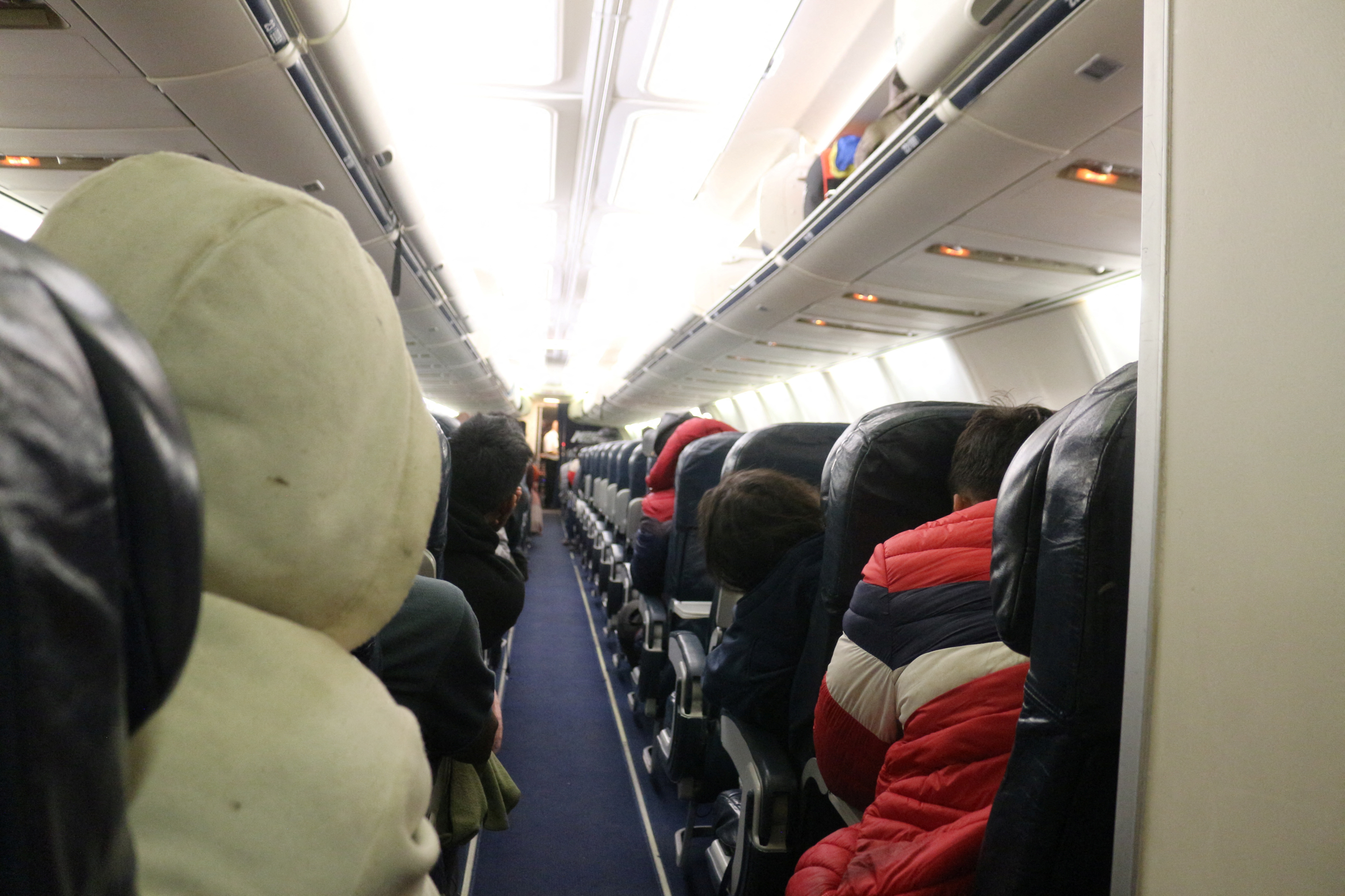 Migrants sit on a plane bound for southern Mexico as part of a repatriation flight to their countries, in Piedras Negras