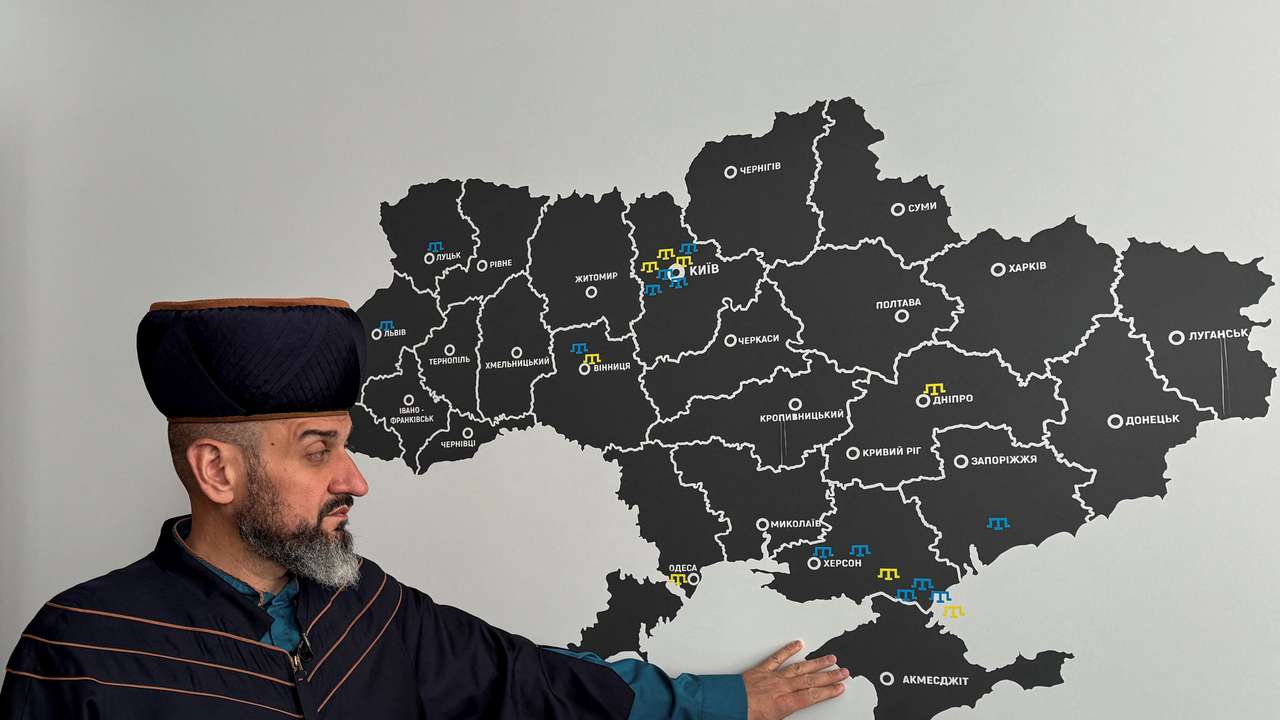 FILE PHOTO: Mufti Rustemov shows Crimea peninsula on a map of Ukraine during an interview with Reuters in Kyiv