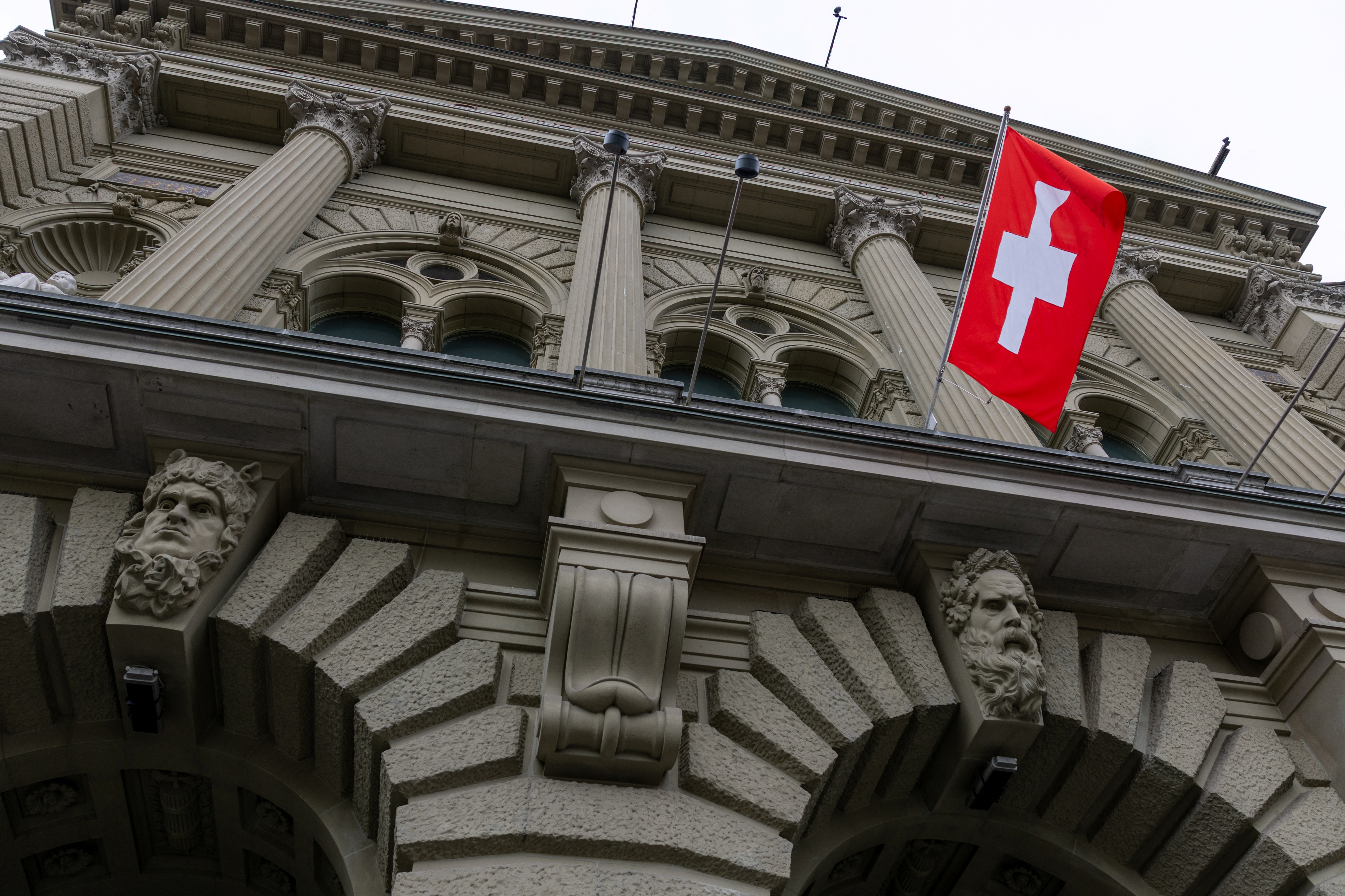 A Swiss flag hangs at the Swiss Parliament building (Bundeshaus) in Bern