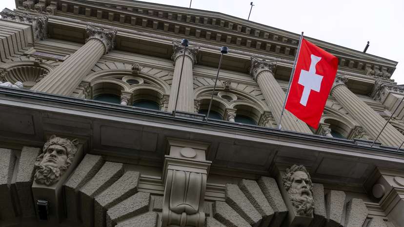 A Swiss flag hangs at the Swiss Parliament building (Bundeshaus) in Bern