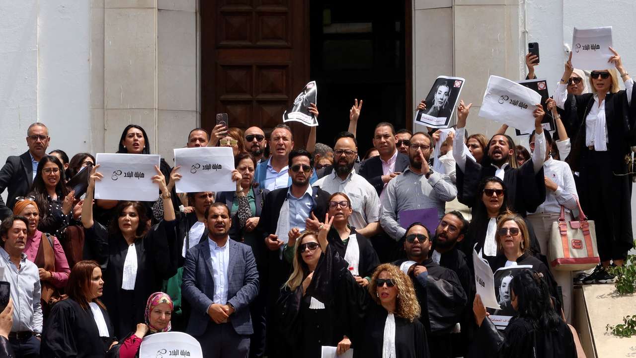 Lawyers carry banners during a protest outside the Palace of Justice building in Tunis