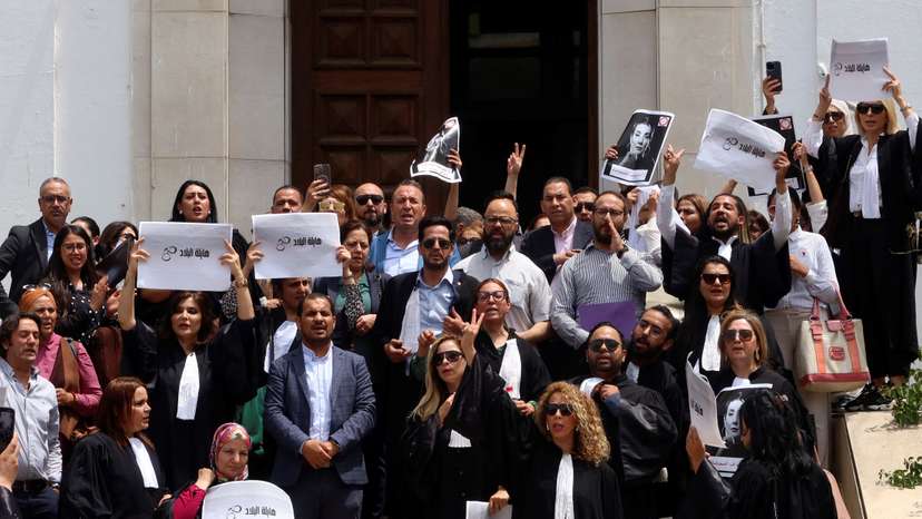 Lawyers carry banners during a protest outside the Palace of Justice building in Tunis