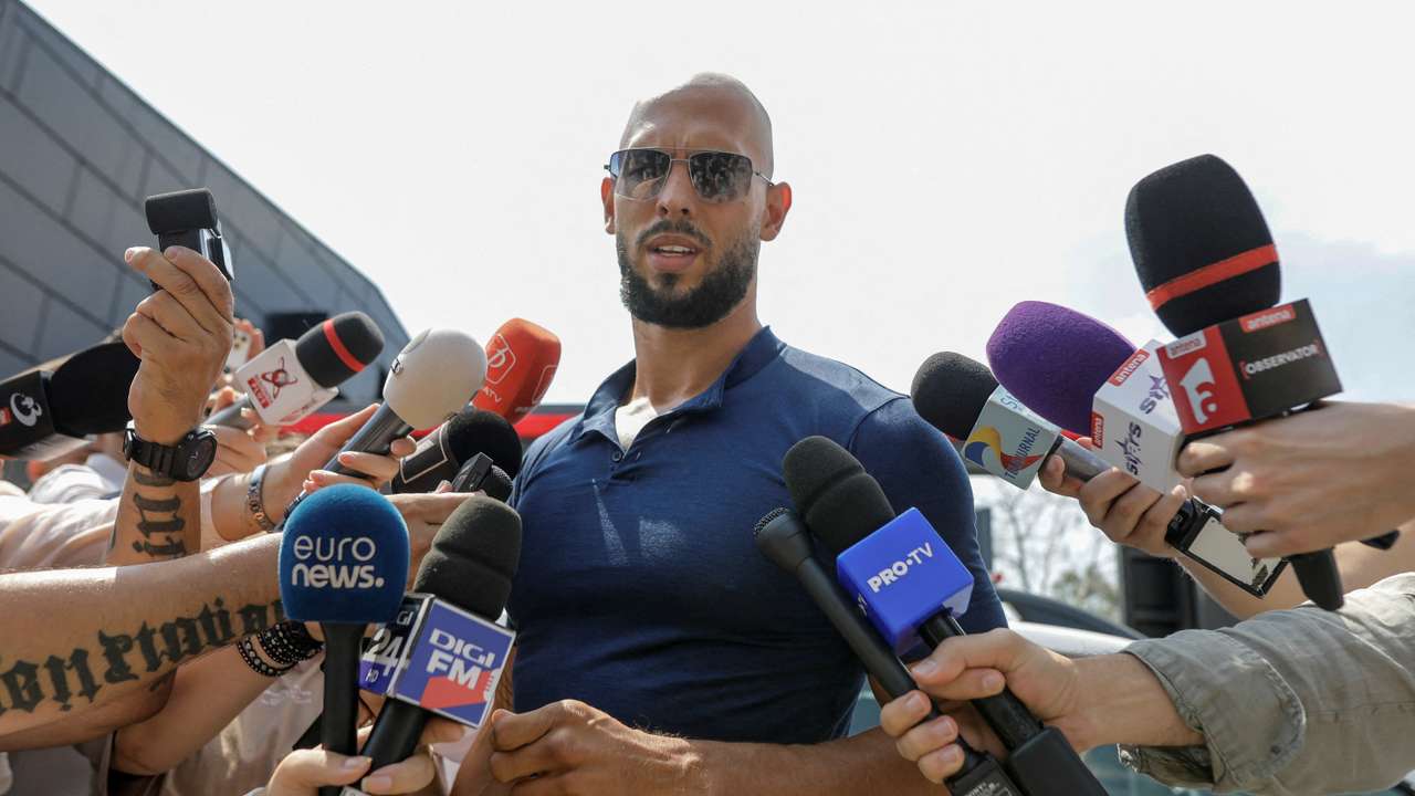 Andrew Tate delivers a press statement outside his house