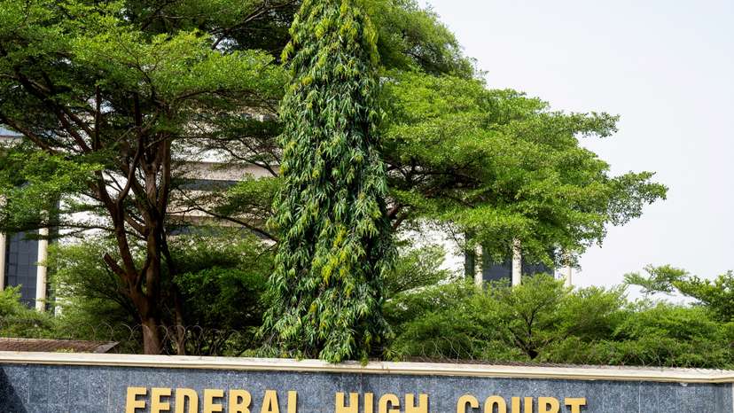 FILE PHOTO: A member of the Nigerian State Security Service walks by the Federal High Court in Abuja.