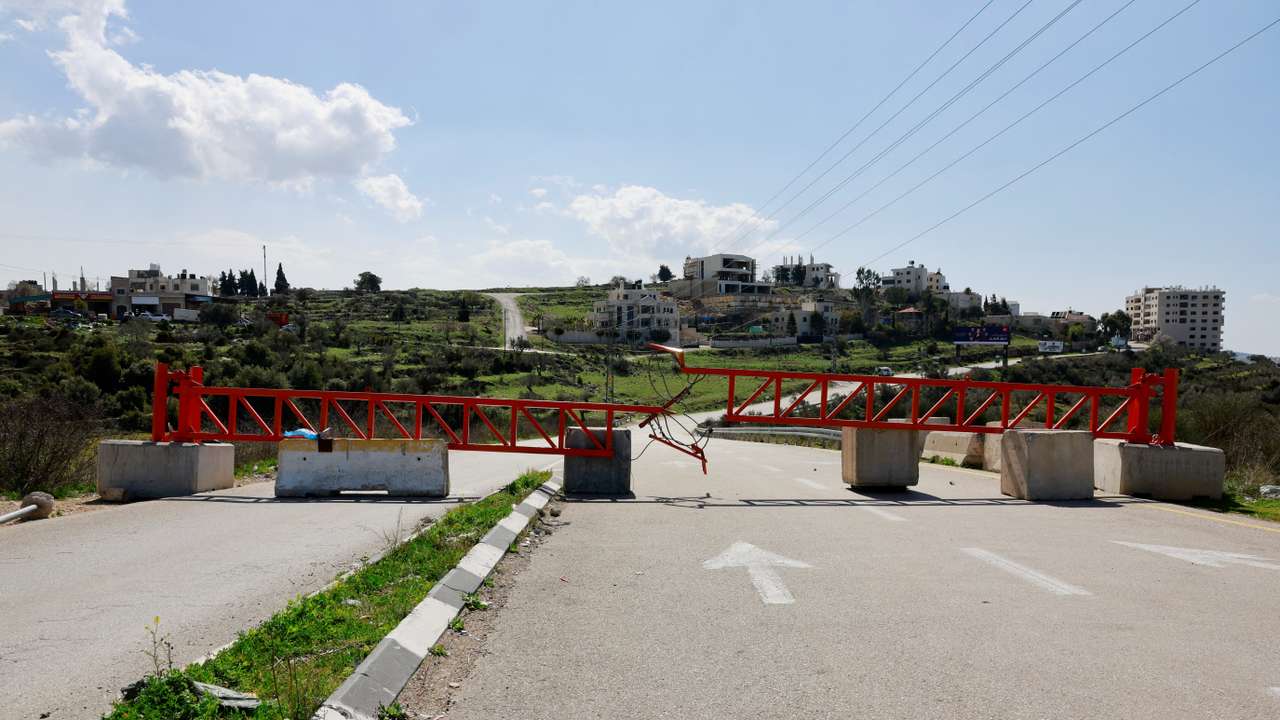 A closed Israeli military gate stands near Ramallah