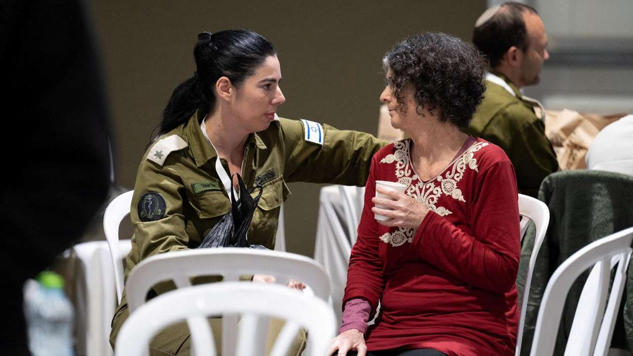 Shoshan Haran, a released Israeli hostage, speaks with an Israeli soldier shortly after her arrival in Israel