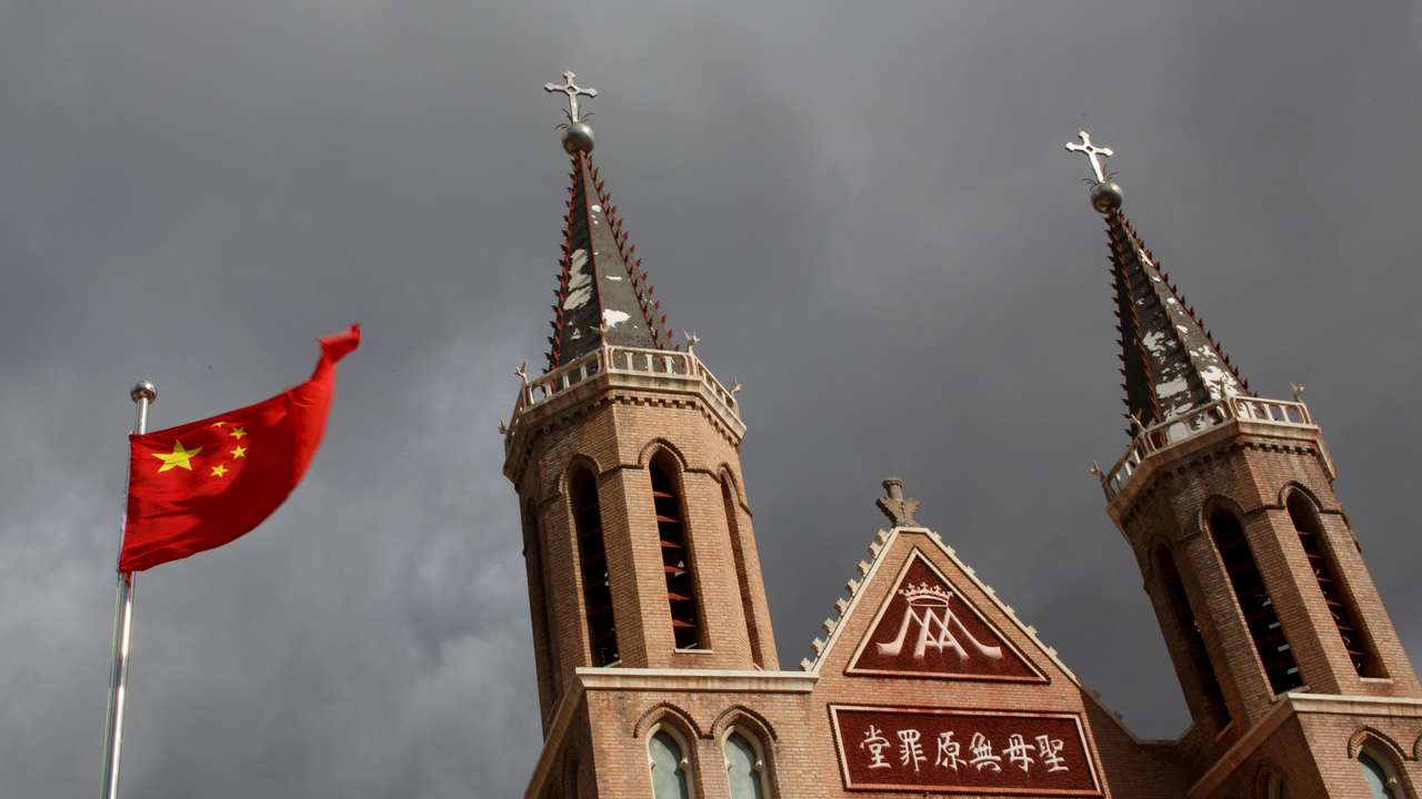FILE PHOTO: The Chinese national flag flies in front of a Catholic underground church in the village of Huangtugang