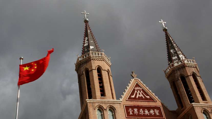 FILE PHOTO: The Chinese national flag flies in front of a Catholic underground church in the village of Huangtugang