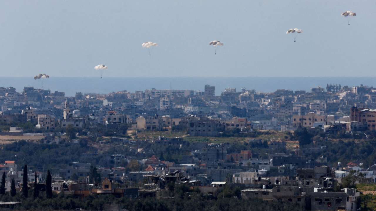 Packages fall towards northern Gaza, as seen from Israel