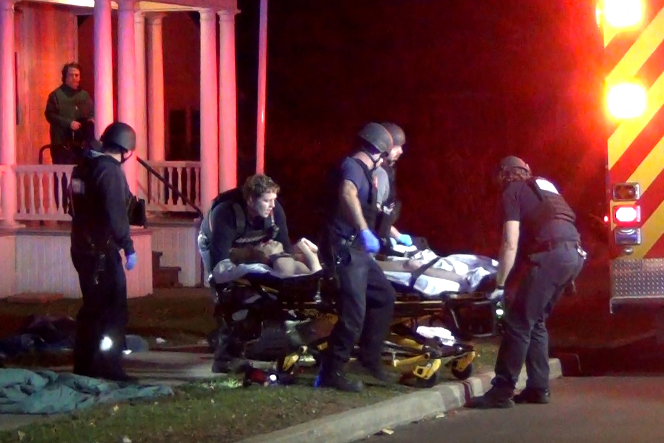 First responders treat a victim after a gunman shot and wounded three college students of Palestinian descent in Burlington