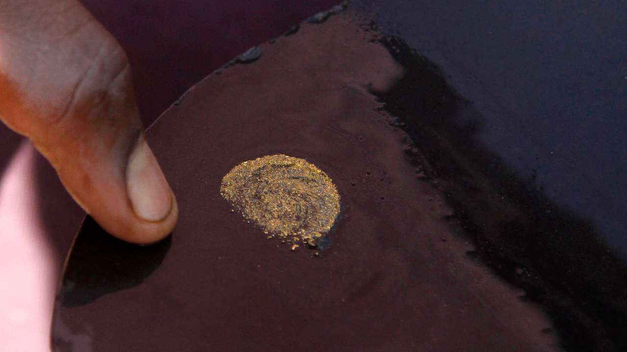 A prospector sorts gold particles found at the Marco gold mine in Mukungwe locality in Walungu territory of South Kivu